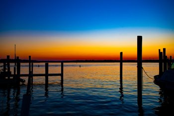 Sunset over Dockside restaurant in Virginia Beach, casting warm colors across the water