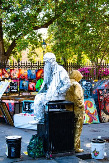 Living statue performer in Jackson Square, New Orleans, showcasing artistry and engagement with the audience