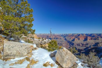 A panoramic view of the Grand Canyon showcasing its vast landscape and colorful rock formations