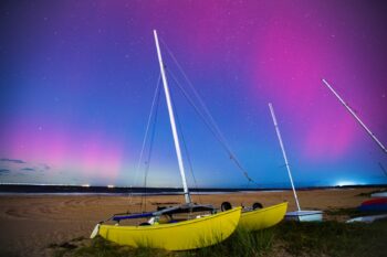 Vibrant northern lights illuminate the night sky over Virginia Beach, creating a stunning natural display