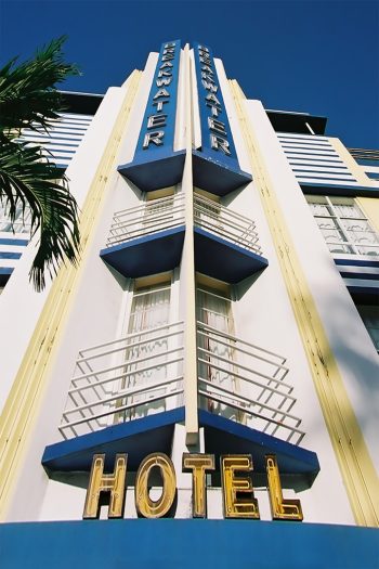 Breakwater Hotel along Ocean Drive in South Beach, Miami Beach, showcasing vibrant beach life and clear blue skies