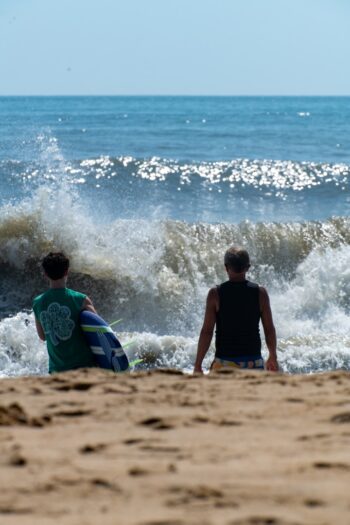 Two servers looking at the waves getting ready to go out