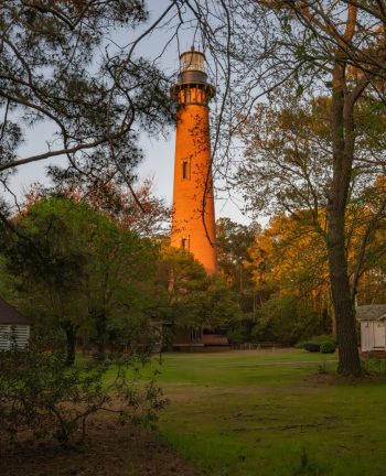 Currituck Beach Lighthouse standing tall against a clear blue sky in Corolla, North Carolina